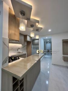 a kitchen with a counter and a sink and a stove at Loft Moderno con aire , con piscina T12 in Neiva