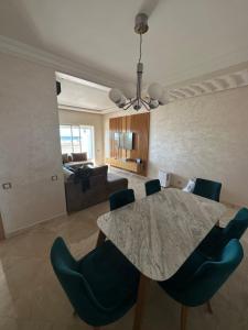 a living room with a table and chairs and a couch at Casa bay sidi rahal in Sidi Rahal