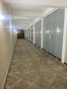 an empty hallway with green lockers in a building at POUSADA AMARELA in Itanhaém