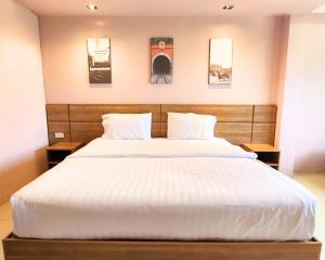Postel nebo postele na pokoji v ubytování AIRBEST Gemtree Lampang Hotel
