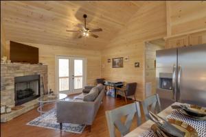 a living room with a couch and a fireplace at New Serene, Fun & Comfy Cabin- Covered Deck, Grill, Arcade in Murphy