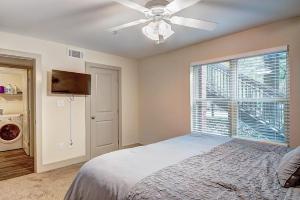 a bedroom with a bed with a ceiling fan and a window at Downtown Atlanta’s hidden gem! in Atlanta
