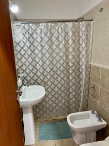 a bathroom with a toilet and a sink and a shower at Depto 8 - Villa Carlos Paz in Villa Carlos Paz