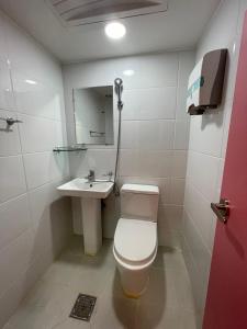 a small bathroom with a toilet and a sink at SSH LK Hostel in Seoul