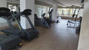 a gym with several treadmills and exercise bikes at Salinas Park Resort in Salinópolis