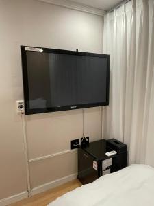 a large flat screen tv on the wall of a hotel room at SSH LK Hostel in Seoul