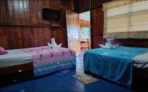 Ένα ή περισσότερα κρεβάτια σε δωμάτιο στο Hospedaje El tigrillo