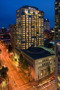 a large building with a sign on the top of it at Delta Hotels by Marriott Vancouver Downtown Suites in Vancouver