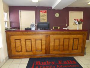 a wooden bar in a restaurant with a cash register at Cascades Motel - Chattanooga in Chattanooga