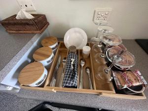 a tray filled with dishes and utensils on a counter at Sunflower Motel in Warialda