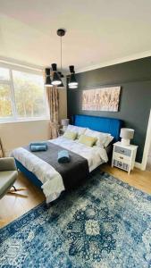 a bedroom with a large bed and a rug at Family Marine Apartment with Sea View in Dawlish