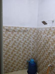 a bathroom with a brown and white tiled wall at ARYAN HOMESTAY Temerloh in Temerloh