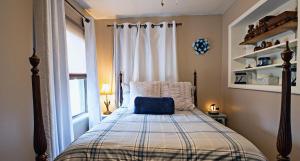 a bedroom with a bed with a blue pillow on it at 1 Sweet Retreat in Nashville +22 photos