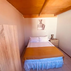 מיטה או מיטות בחדר ב-CASA TAMBO