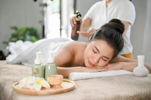 a woman laying on a towel in a massage room at Everest Boutique Hotel in Kathmandu