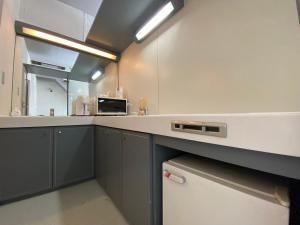 a kitchen with gray cabinets and a counter top at ザ・ヴィレッジアルファ in Tomamu