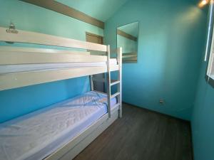 a bunk bed room with two bunk beds in it at Appartement Gruissan, 1 pièce, 4 personnes - FR-1-229-863 in Gruissan