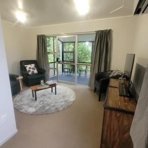a living room with a couch and a table at Couples Retreat in Reefton