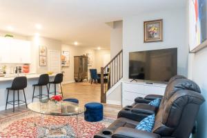 a living room with a couch and a large screen tv at 3bed 2.5 bath town house in Carmel in Carmel