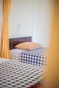 Postel nebo postele na pokoji v ubytování Skybird Homestay