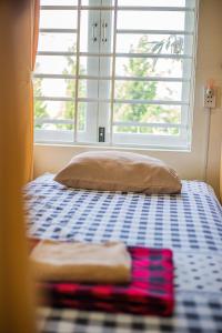 Postel nebo postele na pokoji v ubytování Skybird Homestay