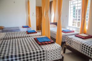 Postel nebo postele na pokoji v ubytování Skybird Homestay
