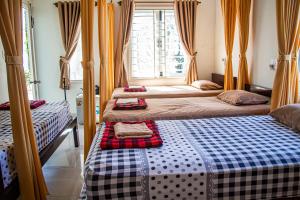 Postel nebo postele na pokoji v ubytování Skybird Homestay