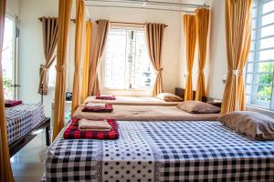 Postel nebo postele na pokoji v ubytování Skybird Homestay