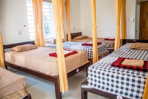 Postel nebo postele na pokoji v ubytování Skybird Homestay