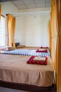 Postel nebo postele na pokoji v ubytování Skybird Homestay