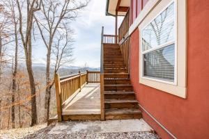 a staircase leading up to a house with a window at Red Rooster Family Cabin w/Hot Tub+Fire Pit+View in Franklin