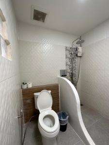 a bathroom with a toilet and a bath tub at Kala Krang Nueng in Ko Samed