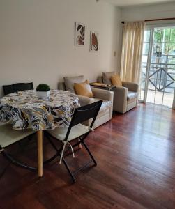 a living room with a table and a couch at Bienestar Haedo in Mariano J. Haedo