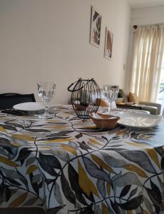 a dining room with a table with a patterned table cloth at Bienestar Haedo in Mariano J. Haedo