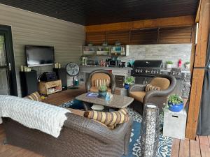 a living room with couches and a kitchen at Stay549 in Winnipeg