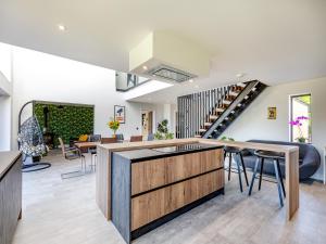 a kitchen and living room with a staircase in a house at The Black Barn in Marldon