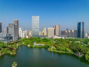 an aerial view of a city with a river and buildings at RiZhao Mumian Hotel in Rizhao