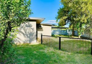 a black fence in front of a house at Grabber- Three bedroom charm in Alice Springs in Alice Springs