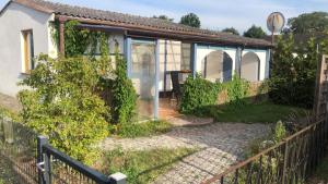 a house with a fence in front of it at Bungalow Usedom in Koserow