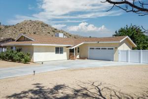 a house with a mountain in the background at Peaceful Home with Nature Views & Trail Access in Yucca Valley