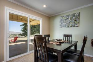 a dining room with a table and chairs and a window at Peaceful Home with Nature Views & Trail Access in Yucca Valley
