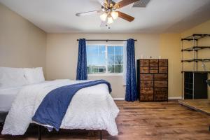 a bedroom with a bed and a ceiling fan at Peaceful Home with Nature Views & Trail Access in Yucca Valley