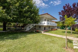 a large house with a lawn in front of it at Spacious seaside house in Nea Potidaea +15 photos