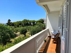a balcony with a view of the ocean at Villa Roseal in Povljana