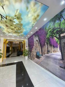 a hallway with a wall with a mural of flowers at En Kaya Hotel in North Nicosia