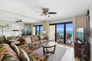 a living room with a couch and a table at Commodore 609 in Panama City Beach