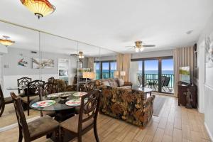 a living room with a table and a couch at Commodore 609 in Panama City Beach