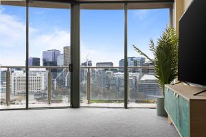 an office with a view of a city from the window at Nook Melbourne Apartments in Melbourne