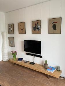 a living room with a flat screen tv on a wall at Wohnen auf Zeit, Boardinghouse, zentral gelegen in Oelde