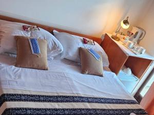 a bed with two pillows on it in a room at Salyna "Bela" balcony in Ičići